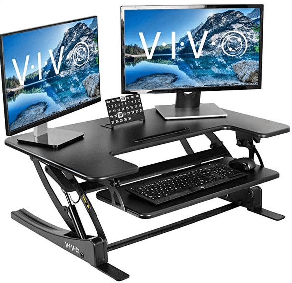 VIVO standing desk with two monitors, calendar, keboard and mouse
