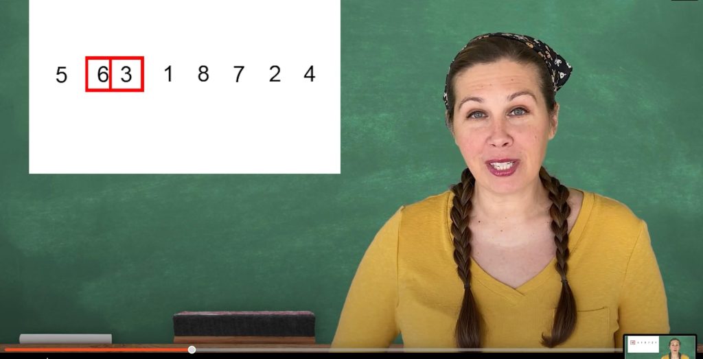 woman in front of chalk board